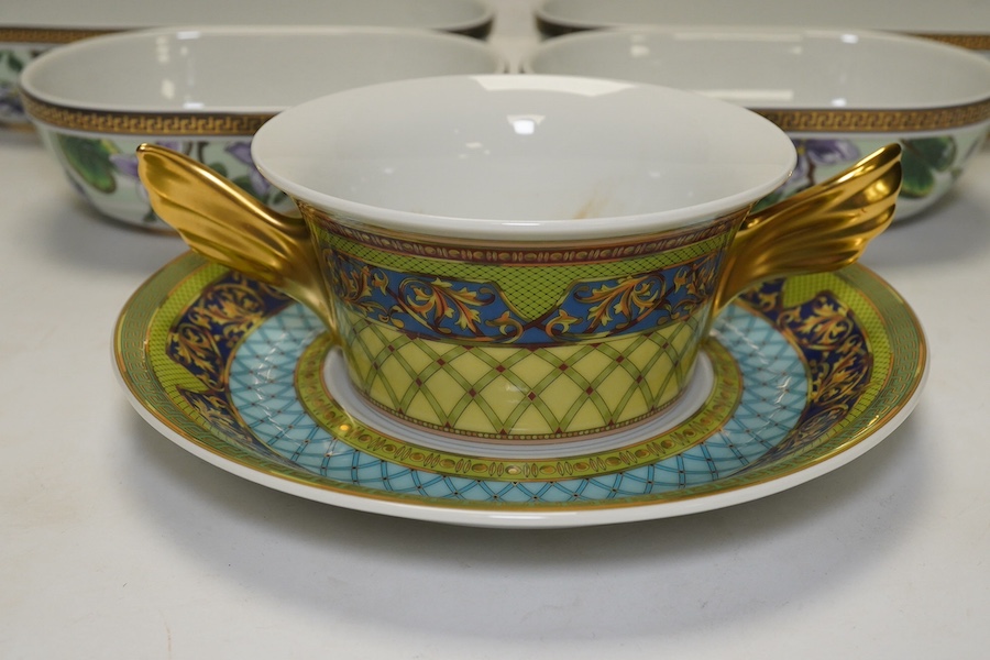 Six Rosenthal for Versace porcelain items; a boxed chocolate cup and saucer, four oblong serving dishes, longest 23cm, and a boxed miniature timepiece, 8.5cm high. Condition - good.